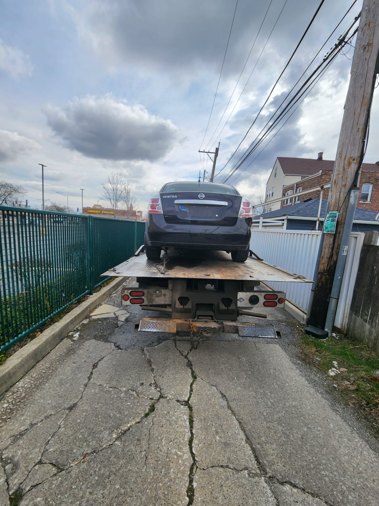 Junk car loaded and secured for removal in Chicagoland